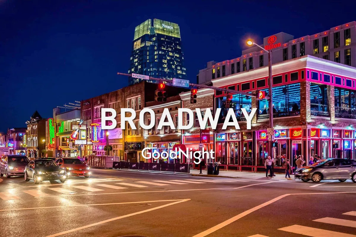 A bustling downtown street scene with neon signs illuminating busy sidewalks, high-rise buildings, and crowds enjoying the nightlife. The energetic atmosphere is unmistakably Nashville, hinting at the excitement of Broadway’s honky-tonks and live music venues.